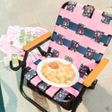 ParkIt Chair with the signature Nora fleming pattern with a cooler and drink holder with chip and dip platter chips and salsa, a drink and poolside