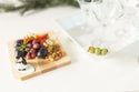 martini olive on s melamine platter with a square wood board and penguin mini