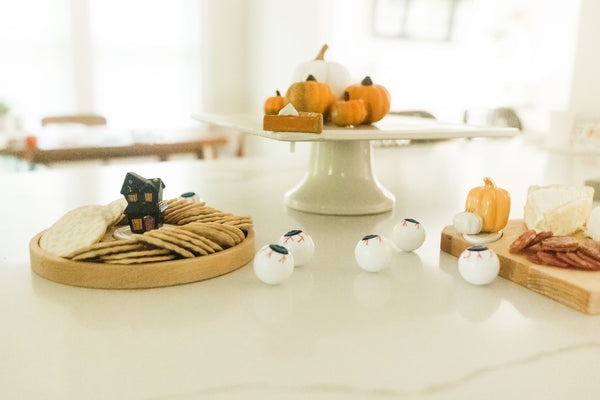 pumpkin pie mini on cake stand and haunted house mini on round wood board and pumpkin mini on wood board