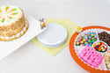 chick in egg mini on a divided melamine dish with an orange band next to a cake stand with a carrot cake and a bunny mini