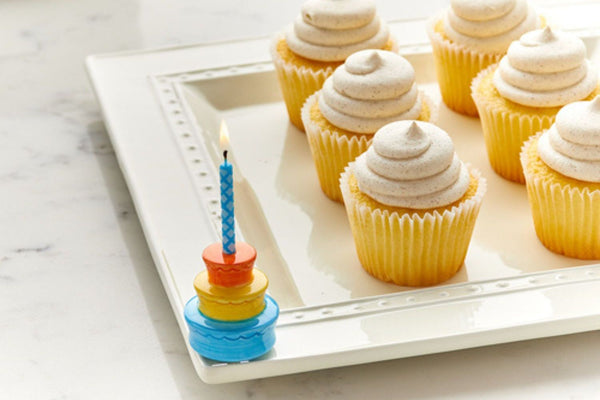 birthday cake mini with a candle and platter with cupcakes