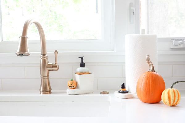 witch hat mini on melamine paper towel holder and pumpkin mini on soap dispenser