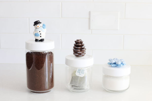 pinecone mini on medium canister and snowman mini on large container and snowflake mini on small container