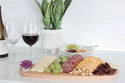 purple flower and woodboard cheese and fruit