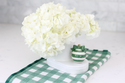 green and white ornament and cutie container and flowers