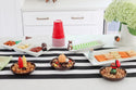assortment of football, acorn, squirrel, pumpkin, ketchup and mustard and grill minis with dainty dishes, cracker trays and utensil crock