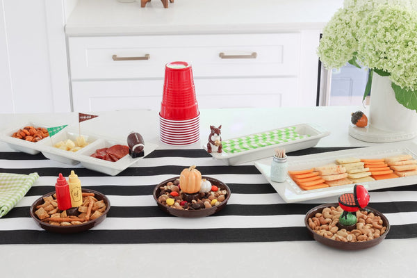 assortment of football, acorn, squirrel, pumpkin, ketchup and mustard and grill minis with dainty dishes, cracker trays and utensil crock