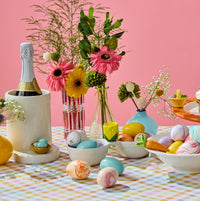 easter table setting with carrot mini, bird in an egg mini, easter basket mini, robbins egg in nest mini, easter bunny mini with crock base, double dipper base, bowl, round platter on a riser, small container, rectangle revamp white platter.