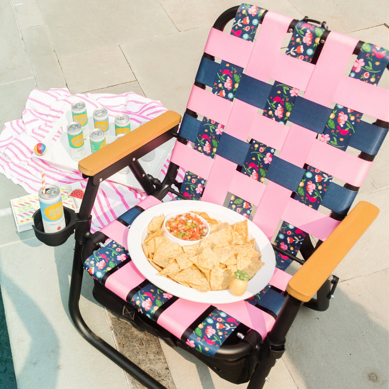 ParkIt Chair with the signature Nora fleming pattern with a cooler and drink holder with chip and dip platter chips and salsa, a drink and poolside