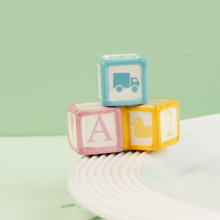 Colorful baby blocks with letters and symbols mini on a light green background