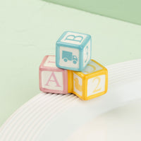 Colorful baby blocks with letters and symbols mini on a light green background