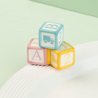 Colorful baby blocks with letters and symbols mini on a light green background