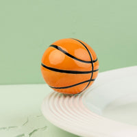 basketball mini on a white surface with a green background
