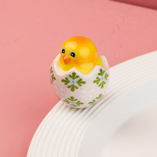 ceramic chick mini with a floral patterned egg on a pink background