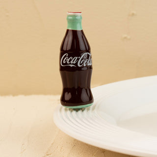 Coca-Cola bottle mini on a beige background