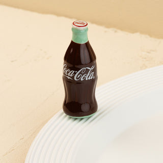 Coca-Cola bottle mini on a beige background