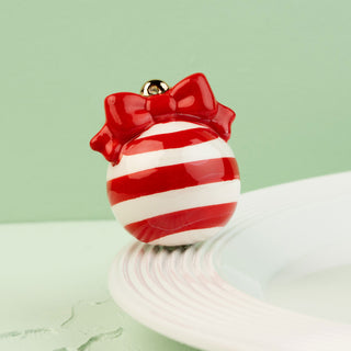 Red and white striped mini with a bow on a light green background