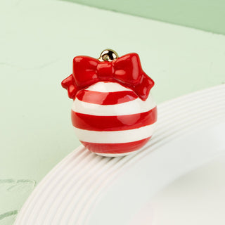Red and white striped mini with a bow on a light green background