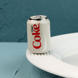 Diet Coke can mini on a white plate with a blue background