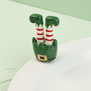 elf legs with striped socks mini on a green background