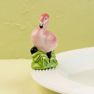 flamingo mini on a white platter and light green background