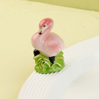 flamingo mini on a white platter and light green background