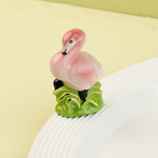 flamingo mini on a white platter and light green background