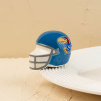 A small, blue University of Kansas football helmet with a Jayhawk logo on it.