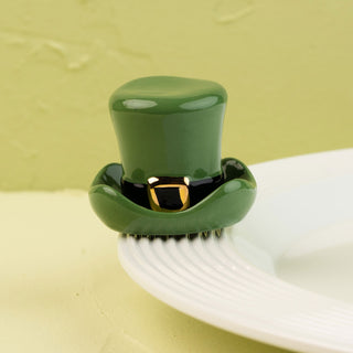Green top hat on a white plate with a green background