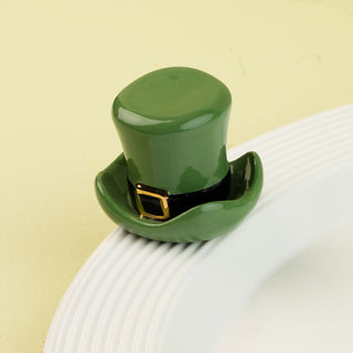 Green top hat on a white plate with a green background