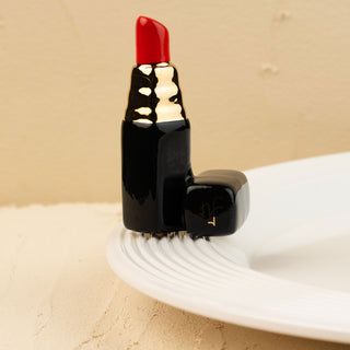 Red lipstick mini on a white platter with a beige background