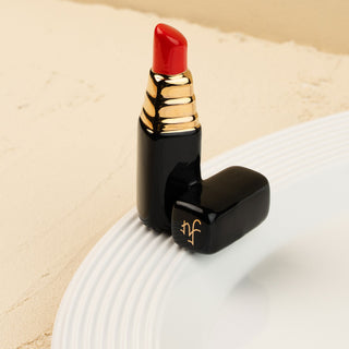 Red lipstick mini on a white platter with a beige background