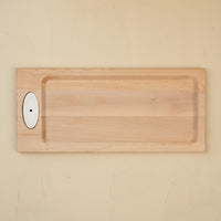 This image features a handcrafted maple bread board designed by J.K. Adams