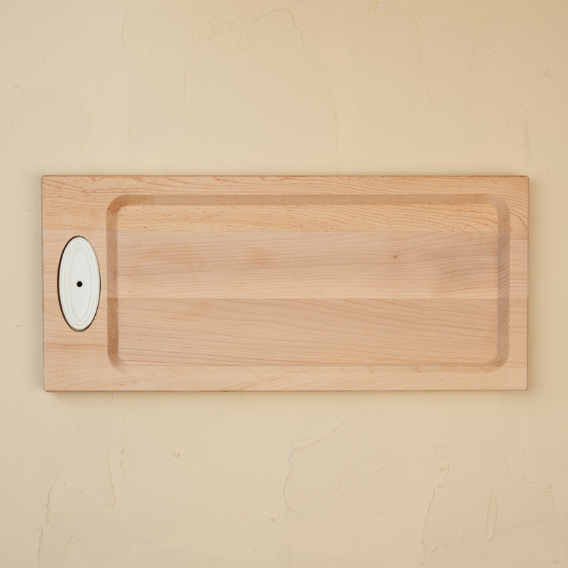This image features a handcrafted maple bread board designed by J.K. Adams