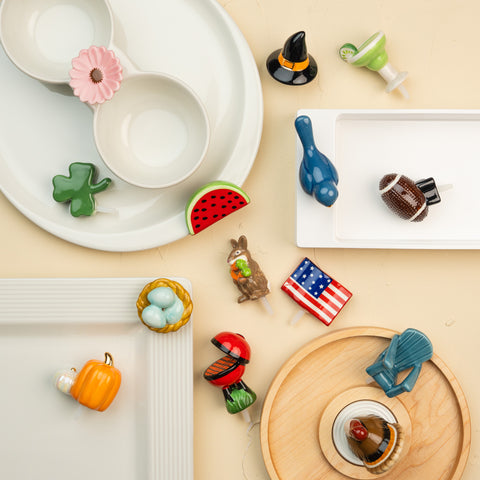 Collection of decorative items on a beige surface, including bowls and small figurines.