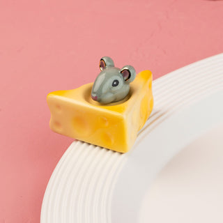 Small gray mouse on a yellow wedge of cheese mini with a pink background