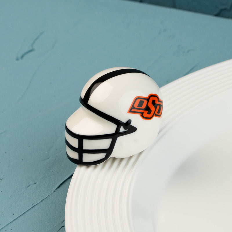 A small, decorative Oklahoma State University helmet mini with a logo on the side.