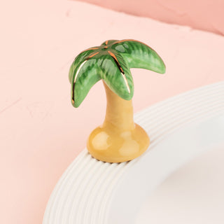 Palm tree-shaped mini on a white platter with a pink background