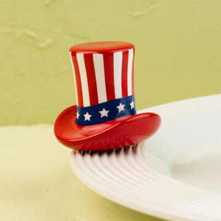 Red, white, and blue top hat-shaped mini on a white plate with a yellow background