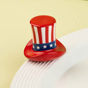 Red, white, and blue top hat-shaped mini on a white plate with a yellow background