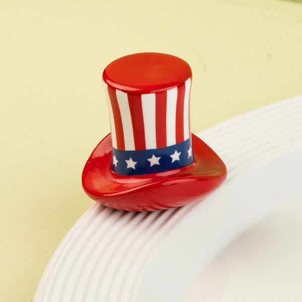 Red, white, and blue top hat-shaped mini on a white plate with a yellow background