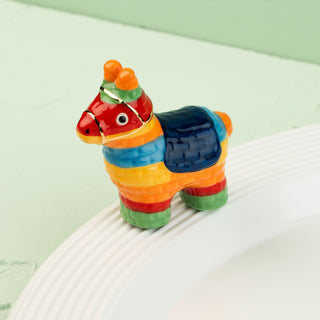 Colorful llama-shaped mini on a white surface with a light green background
