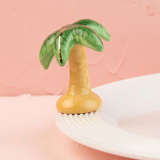 Palm tree-shaped mini on a white platter with a pink background