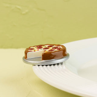 Miniature pizza mini on a white plate with a light green background