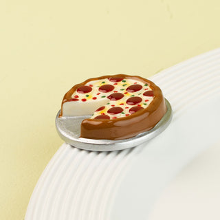 Miniature pizza mini on a white plate with a light green background