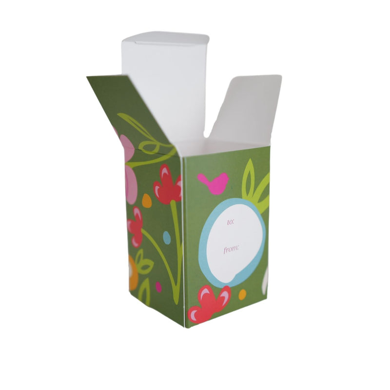 A green gift box with floral patterns, open and empty, designed for presenting a mini keepsake.