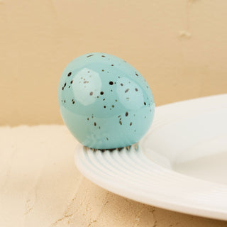 Turquoise robin's egg on a beige background