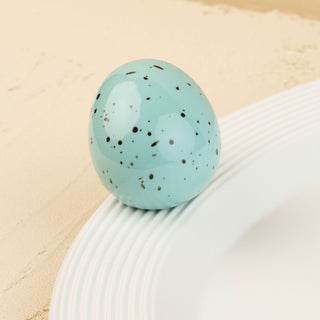 Turquoise robin's egg on a beige background