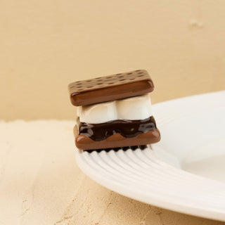 Miniature s'mores minin on a beige background