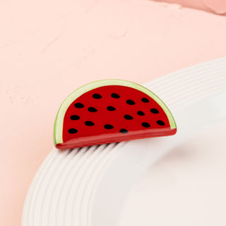 Watermelon-themed mini on a white plate with a pink background